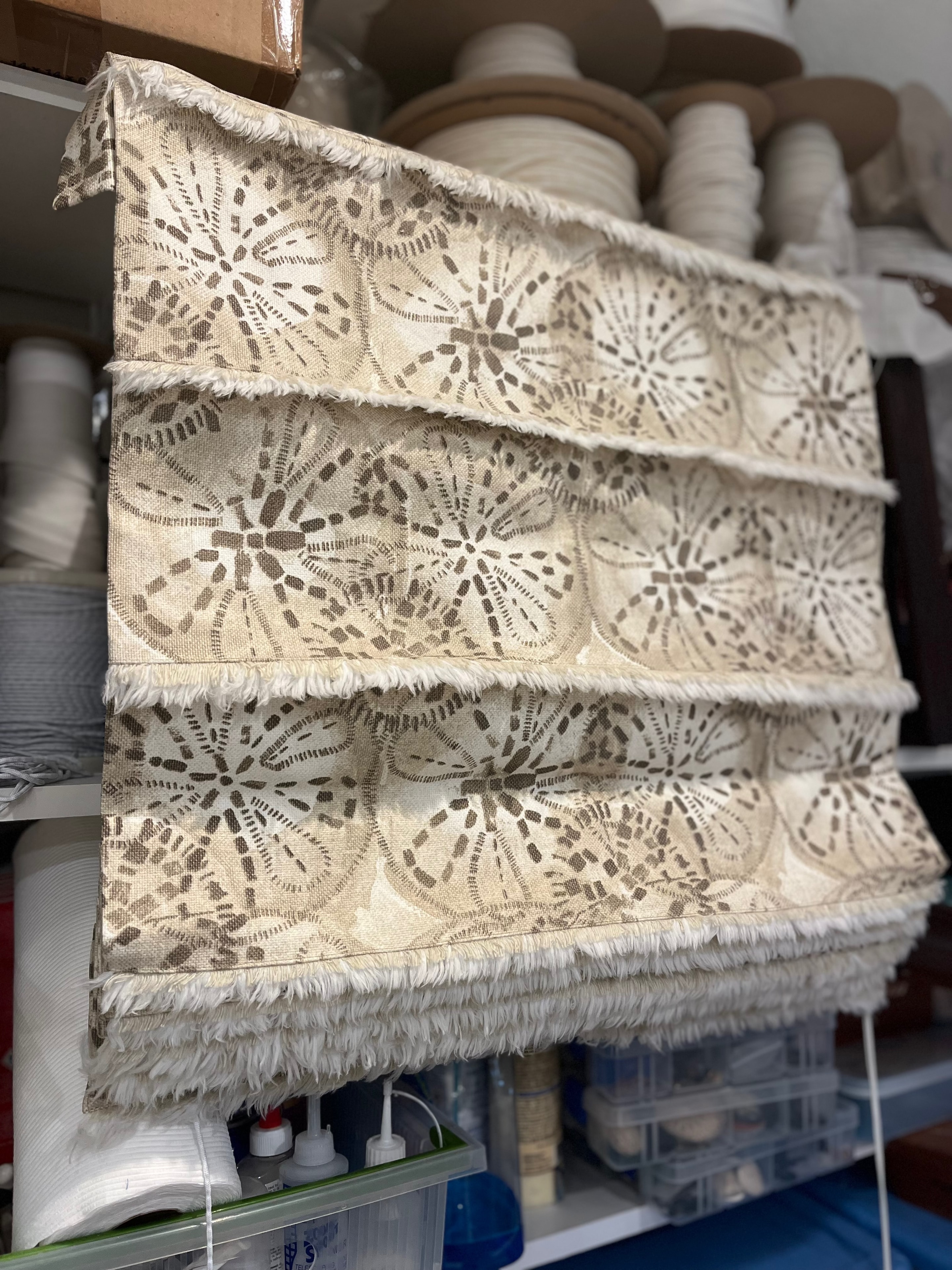 Cream lace fabric with fuzzy selvedge added to folds