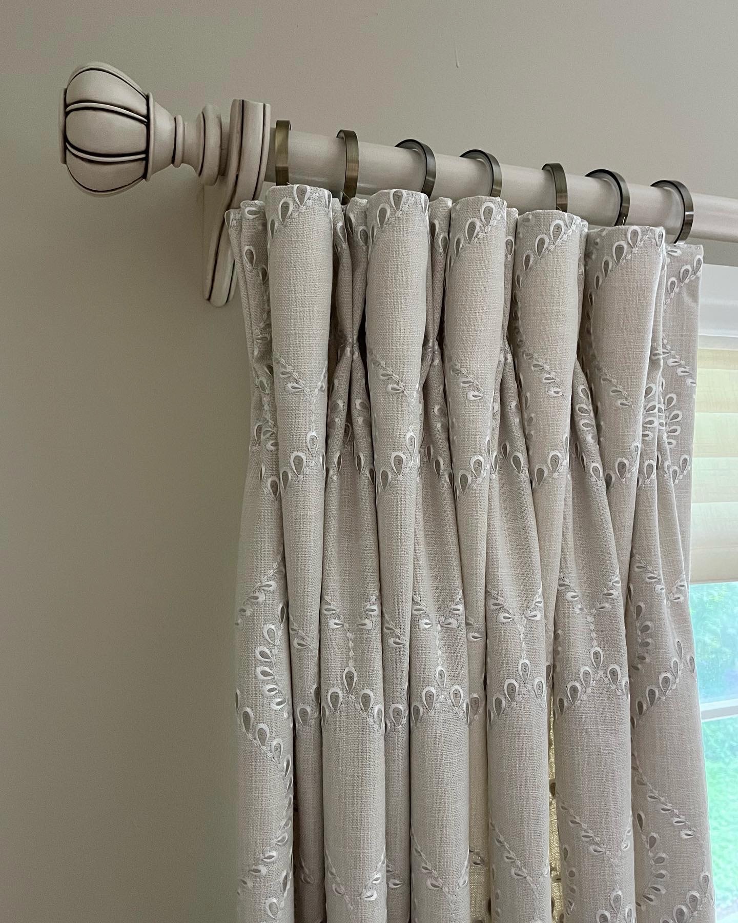 Goblet pleated drapes in embroidered linen on decorative rod
