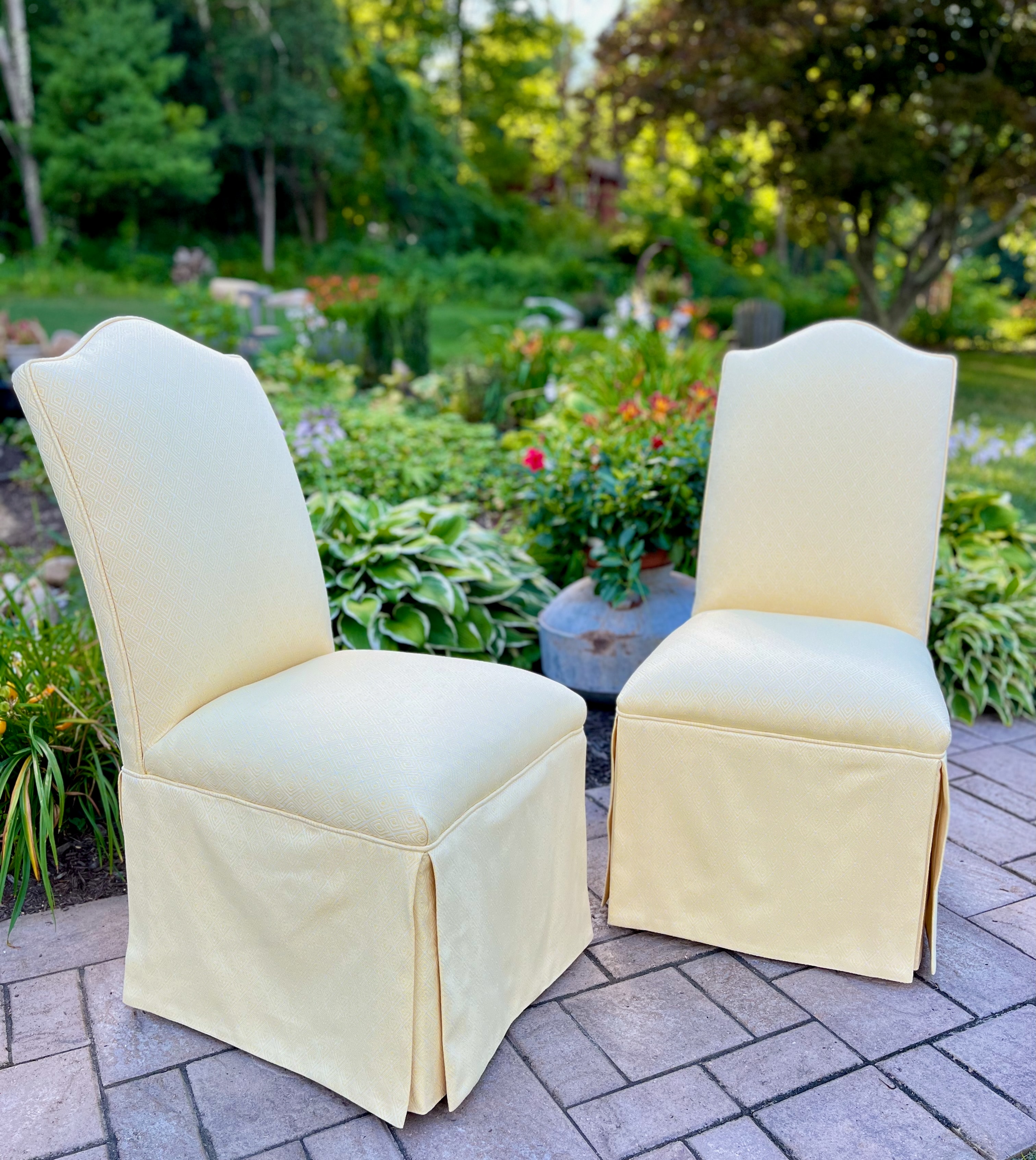 Upholstered dining chairs with full skirts on garden patio