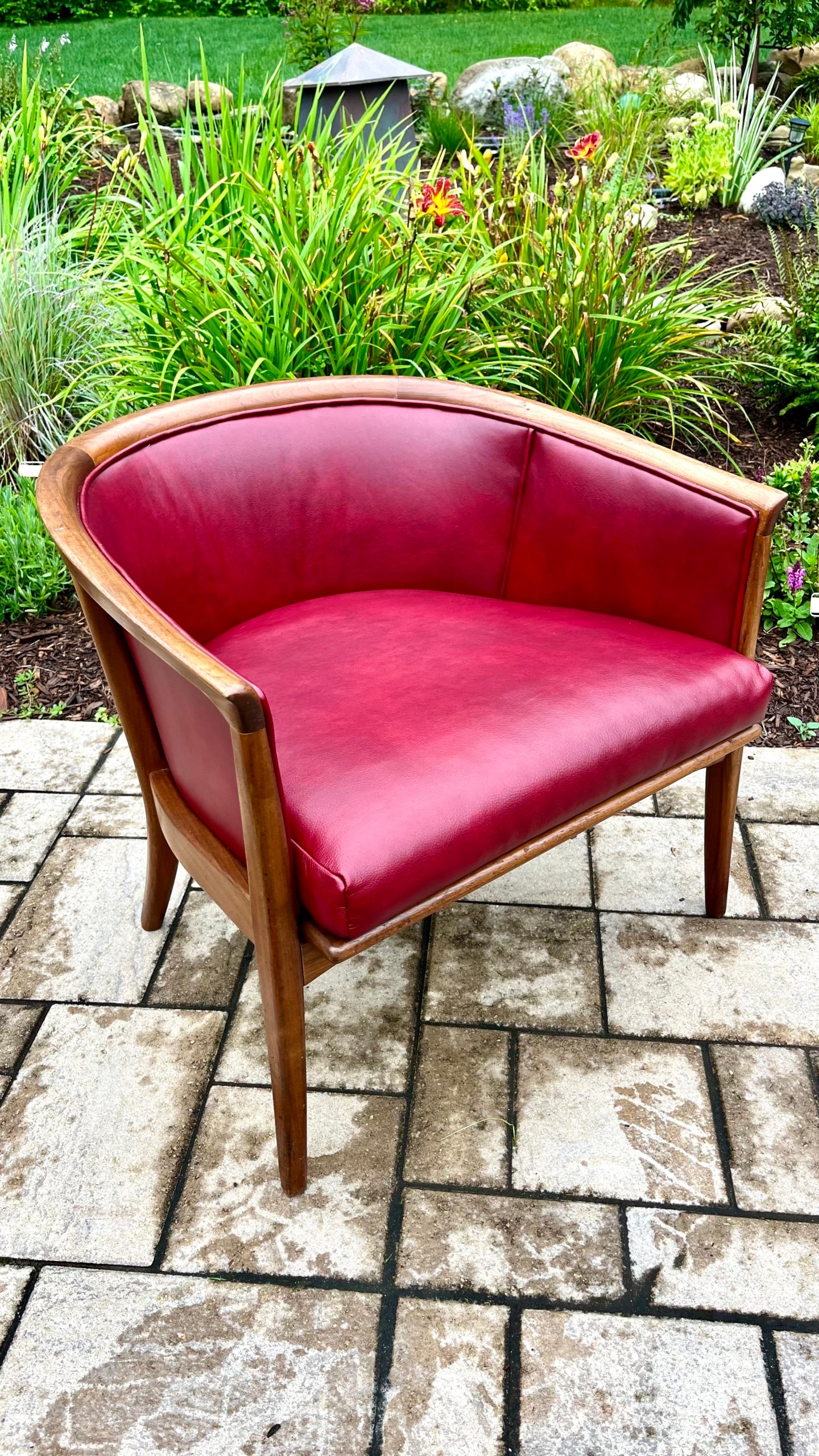 Red velvet armchair on garden patio setting